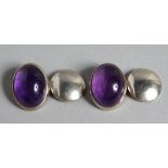 A PAIR OF SILVER AND AMETHYST CUFF LINKS.