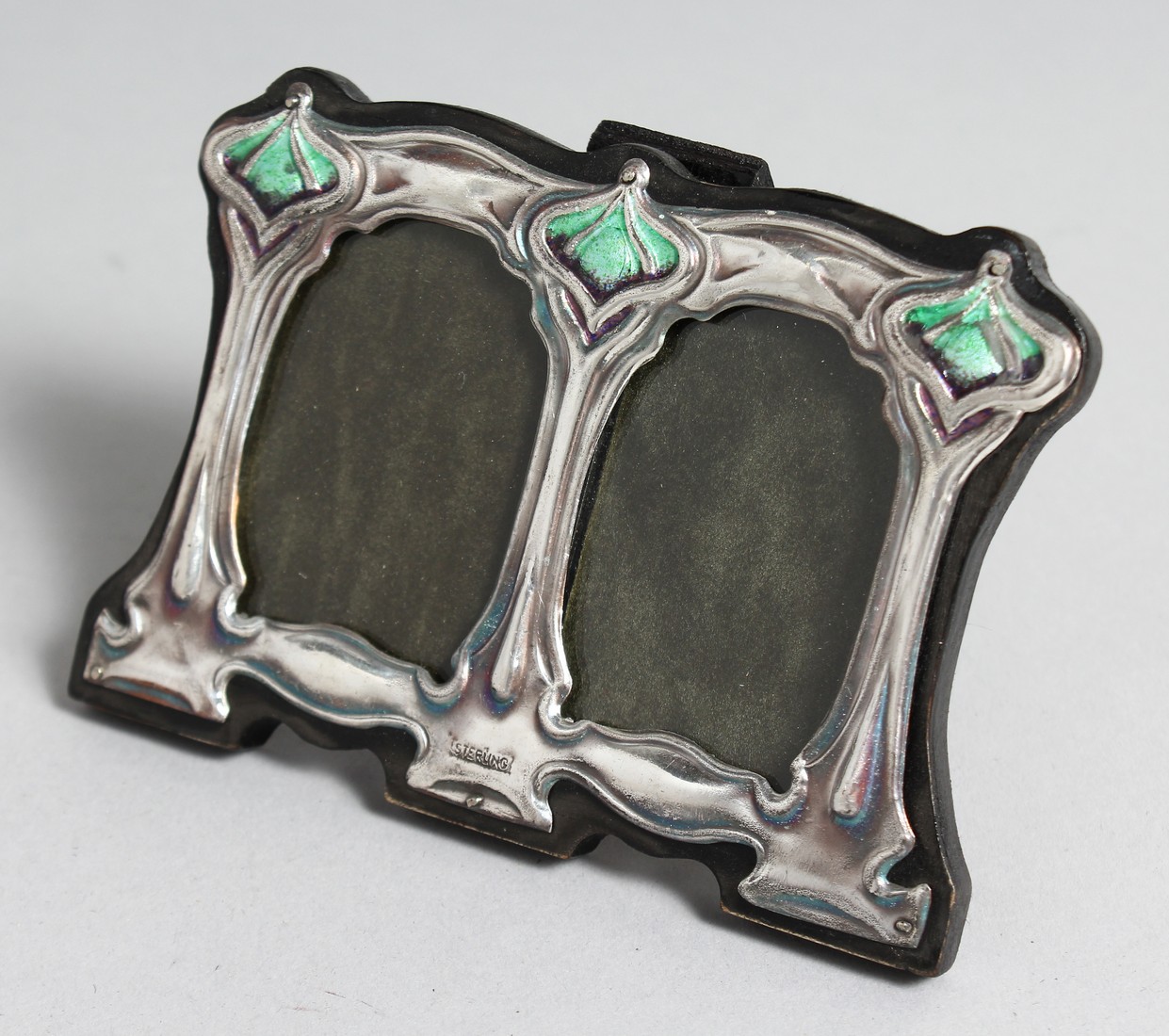A SMALL SILVER AND ENAMEL DOUBLE FRAME.