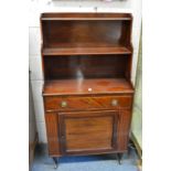 A small mahogany cupboard bookcase with open shelves above a single drawer and cupboard door.
