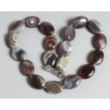 A SCOTTISH OVAL AGATE BEAD NECKLACE 17ins long.