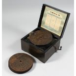 A 19TH CENTURY GERMAN SYMPHONIUM with TWELVE 5.5 discs in a faux rosewood case 7.5ins x7.5ins.