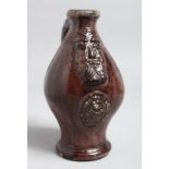 AN USUAL BROWN BELLARMINE JUG 7ins high.