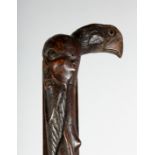 AN UNUSUAL WALKING STICK with a Chinese man's head and bird's head.