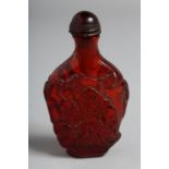 A CARVED AMBER SNUFF BOTTLE AND STOPPER.
