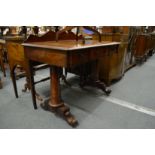 A 19th century mahogany three drawer side table on plain column supports with carved feet.