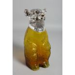 A YELLOW GLASS BEAR CLARET JUG with plated head.