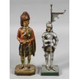 TWO NOVELTY LIGHTERS, a man in armour and a Scottish Highlander. 10ins high.