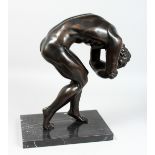 A BRONZE MAN LEANING OVER on a marble base. 16ins high.