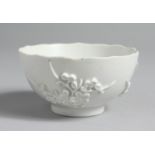 A GOOD EARLY BOW BLANC DE CHINE PETAL EDGED TEA BOWL with applied sprigs of prunus incised line to