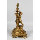 A GOOD 19TH CENTURY FRENCH ORMOLU CUPID LAMP with fruiting vines and scrolls. 16ins.