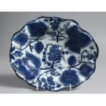 A BOW OVAL DISH moulded with grape leaves and painted in underglaze blue with grapes and vine.