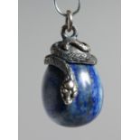 A RUSSIAN SILVER AND ENAMEL EGG PENDANT with snake.
