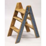 A PAIR OF NOVELTY ADVERTISING PINE STEPS. 2ft 8ins high.