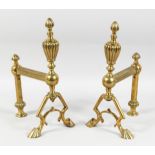 A PAIR OF VICTORIAN BRASS ANDIRONS with urn finials and claw feet. 13ins high.