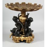 A GOOD GILT BRONZE AND BRASS CUPID COMPORT supported by three cupids.