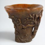 A CHINESE CARVED HORN LIBATION CUP. 6ins high.