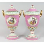 A SUPERB LARGE PAIR OF BERLIN TWO HANDLED URNS AND COVERS painted with reverse panels of figures,