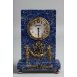 A SUPERB RUSSIAN LAPIS CLOCK mounted with precious stones, Russian eagle and garlands. 4ins high x