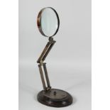 A MAGNIFYING GLASS on a stand.