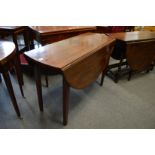 A mahogany drop-leaf dining table.