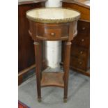 A continental circular marble topped drum table, the fluted legs united by an under tier.