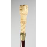 A CARVED BONE HANDLE WALKING STICK "FISH". 36ins long.