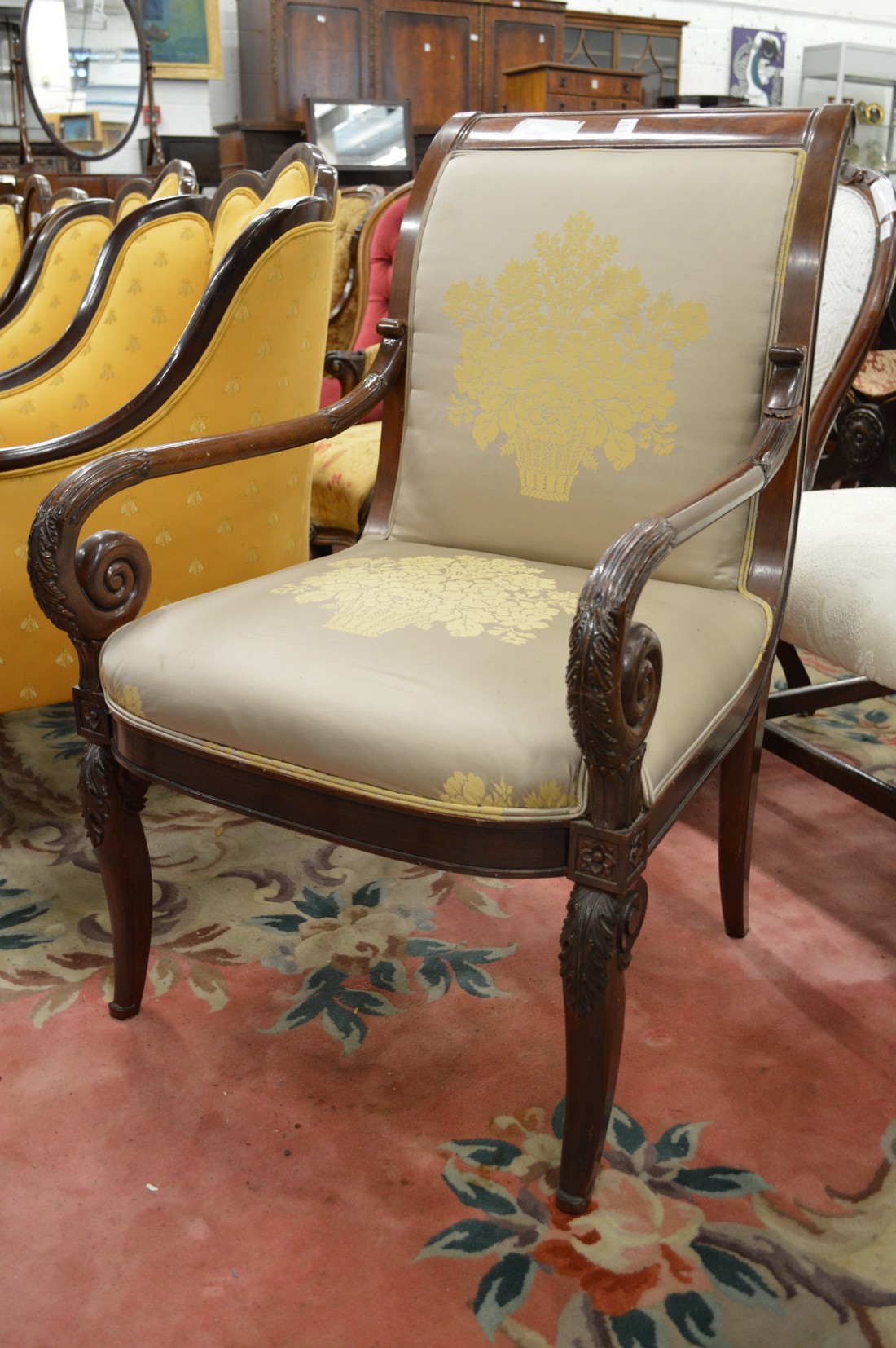 A French Empire revival mahogany framed open armchair.