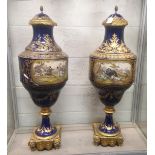 A SUPERB LARGE PAIR OF 19TH CENTURY SEVRES PORCELAIN URNS AND COVERS, rich blue ground with gilt