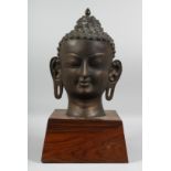 A LARGE BRONZE BUDDHA HEAD on stand. 23ins high.