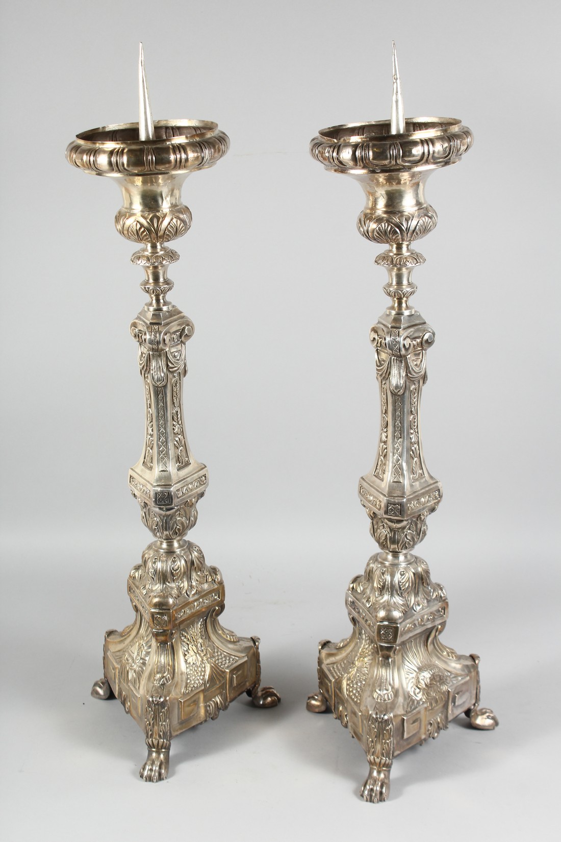 A GOOD PAIR OF CONTINENTAL SILVER PLATE PRICKET CANDLESTICKS. 30ins high.