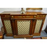 A good Regency rosewood break-front chiffonier with frieze drawers above brass grilled doors.