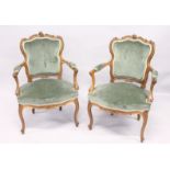 A GOOD PAIR OF FRENCH BEECHWOOD ARMCHAIRS with padded arms and seats, on curving legs.