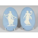 A PAIR OF WEDGWOOD JASPER WARE OVAL PLAQUES, classical female dancers. 5.5ins x 3.5ins.