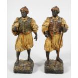 A PAIR OF 19TH CENTURY AUSTRIAN PAINTED NUBIAN STANDING FIGURES. 9ins high.