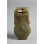 A CHINESE CARVED JADE URN with ring handles.