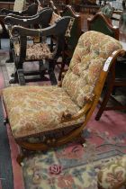 A Victorian walnut ladies' chair.