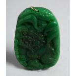 A LARGE CHINESE CARVED GREEN JADE PENDANT. 2.25ins