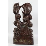 A LARGE CHINESE CARVED WOOD FISH FIGURE with calligraphy. 22ins long.