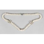 A GOOD CHANEL PEARL AND DOUBLE 'C' NECKLACE. 65 pearls, 28ins long in a black Chanel box.