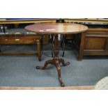 A George III mahogany circular tilt top tripod table.