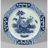 A BOW PLATE PAINTED IN UNDERGLAZE BLUE with bamboo and an elaborate diaper border.