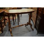 A Victorian walnut and leather inset top kidney shaped stretcher table.