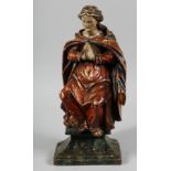 AN 18TH CENTURY, POSSIBLY ITALIAN, CARVED POLYCHROME FIGURE of a praying saint. 15ins high.