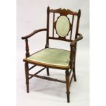 AN EDWARDIAN MAHOGANY INLAID ARMCHAIR with padded back and seat.