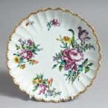 A BEAUTIFUL BOW SCALLOPED CIRCULAR DISH lavishly painted with large flower sprays.