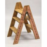 A PAIR OF NOVELTY ADVERTISING PINE STEPS. 2ft 8ins high.