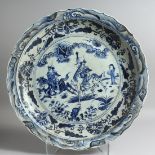 A LARGE CHINESE BLUE AND WHITE CIRCULAR DISH. 20ins diameter.