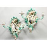 A PAIR OF THREE-BRANCH PORCELAIN WALL LIGHTS IN THE MEISSEN STYLE, decorated with cherubs,