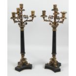 A GOOD PAIR OF FOUR LIGHT CANDLESTICKS on eagle bases. 23ins high.