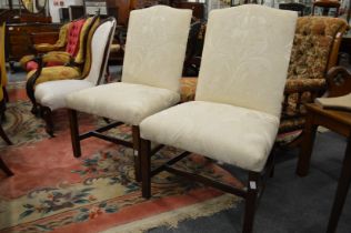 A pair of George III style cream upholstered side chairs.
